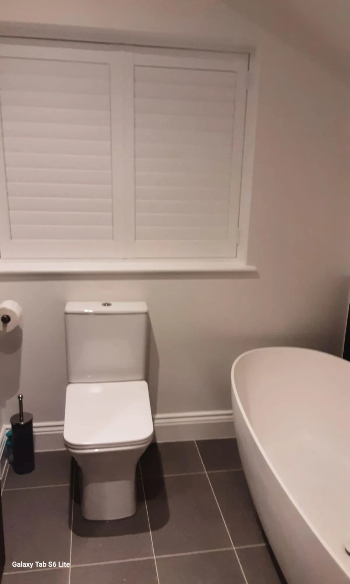Full-height plantation shutters fitted in a bathroom for privacy
