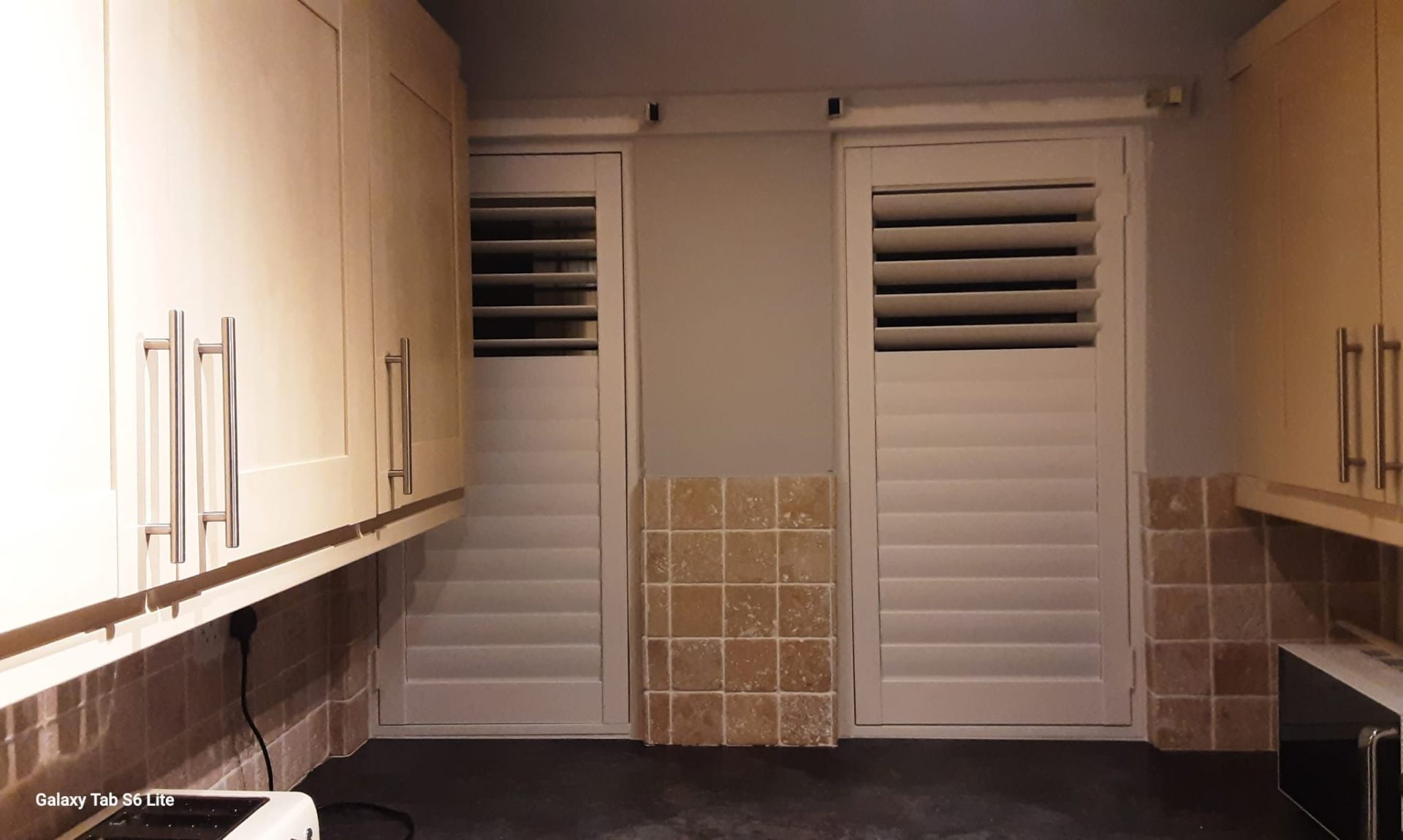 Bay window plantation shutters with louvres open flooding room with light